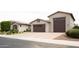 A well-maintained exterior with multi-car garage and neutral color palette at 9187 W Parkside Ln, Peoria, AZ 85383