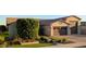 Home's exterior showcasing landscaped front yard, stone accents, and three-car garage at 9187 W Parkside Ln, Peoria, AZ 85383