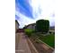 Landscaped front yard featuring gravel, grass, and plants at 9187 W Parkside Ln, Peoria, AZ 85383