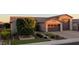 Home's exterior showcasing landscaped front yard, stone accents, and three-car garage at 9187 W Parkside Ln, Peoria, AZ 85383