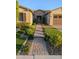 Charming home with a stone-accented entryway and a well-manicured lawn and walkway at 9187 W Parkside Ln, Peoria, AZ 85383