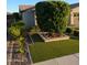 Lush front yard featuring manicured greenery and rock-lined garden beds near the home at 9187 W Parkside Ln, Peoria, AZ 85383