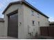 Spacious three-car garage with brown doors and clean exterior finishes at 9187 W Parkside Ln, Peoria, AZ 85383