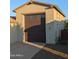 A detached garage with a dark brown door and upper windows complements the home's exterior at 9187 W Parkside Ln, Peoria, AZ 85383