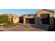 A well-maintained home featuring a three-car garage and landscaped front yard at 9187 W Parkside Ln, Peoria, AZ 85383