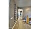 Long hallway with gray walls, tile flooring, and natural light filtering through a window at 9187 W Parkside Ln, Peoria, AZ 85383