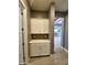 Hallway with built-in storage and view to dining area and kitchen at 9187 W Parkside Ln, Peoria, AZ 85383