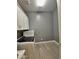 Bright laundry room features wood-look tile flooring, white cabinets and modern washer and dryer at 9187 W Parkside Ln, Peoria, AZ 85383