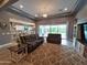 Comfortable living room with a large sectional, stylish area rug, and an open floor plan at 9187 W Parkside Ln, Peoria, AZ 85383