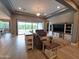 Cozy living room with neutral tones, recessed lighting, and a sliding door that leads to the outdoor space at 9187 W Parkside Ln, Peoria, AZ 85383