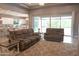 Comfortable living room with neutral tones, plush seating, and sliding glass doors leading to the backyard at 9187 W Parkside Ln, Peoria, AZ 85383