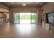Open-concept living space with tile flooring and large sliding glass doors to the backyard at 9187 W Parkside Ln, Peoria, AZ 85383