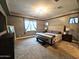 Bright and inviting main bedroom with plush carpeting, modern decor, and ample storage at 9187 W Parkside Ln, Peoria, AZ 85383