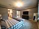 Spacious main bedroom featuring plush carpeting, a tray ceiling, and ample natural light at 9187 W Parkside Ln, Peoria, AZ 85383