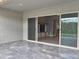 Covered patio area with view to backyard through sliding glass doors at 9187 W Parkside Ln, Peoria, AZ 85383