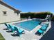 Inviting pool area with lounge chairs, a slide, and spa; perfect for summer relaxation at 9187 W Parkside Ln, Peoria, AZ 85383
