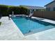 View of the pool with a slide, a spa, and a basketball net for entertainment at 9187 W Parkside Ln, Peoria, AZ 85383