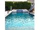Sparkling pool featuring a slide, basketball hoop, integrated hot tub, and surrounding privacy landscaping at 9187 W Parkside Ln, Peoria, AZ 85383