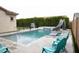 Backyard pool area with slide, basketball hoop, integrated hot tub, and lounge chairs, perfect for entertaining at 9187 W Parkside Ln, Peoria, AZ 85383