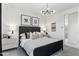 Stylish bedroom boasting a modern light fixture, striped headboard and two framed prints at 9815 S 11Th St, Phoenix, AZ 85042