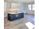 Modern kitchen featuring a large island with counter seating, white cabinets, and stainless steel appliances at 9815 S 11Th St, Phoenix, AZ 85042