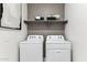 Efficient laundry area equipped with modern appliances and convenient shelving at 9815 S 11Th St, Phoenix, AZ 85042