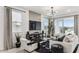 Bright living area with a comfortable seating arrangement, a sleek entertainment center, and a sliding door to the backyard at 9815 S 11Th St, Phoenix, AZ 85042