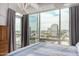 Relaxing bedroom boasts city views through large windows, with stylish curtains and tiled flooring at 1 E Lexington Ave # 1108, Phoenix, AZ 85012