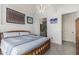 Cozy bedroom featuring neutral tones, tiled floors, a view to a nearby bathroom, and simple decor at 1 E Lexington Ave # 1108, Phoenix, AZ 85012