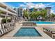 Community space features a modern fire pit surrounded by comfortable striped seating by pool at 1 E Lexington Ave # 1108, Phoenix, AZ 85012