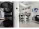 Open concept kitchen with modern appliances, a center island with seating, and stacked washer/dryer at 1 E Lexington Ave # 1108, Phoenix, AZ 85012
