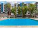 Outdoor swimming pool with comfortable lounge chairs set amidst lush, green palm trees at 1 E Lexington Ave # 1108, Phoenix, AZ 85012