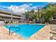 Community pool with blue water and lounge chairs provides relaxation in a modern setting at 1 E Lexington Ave # 1108, Phoenix, AZ 85012