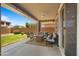 Comfortable covered back patio with cozy fire pit and lounge chairs overlooking a well-kept backyard at 10224 E Talameer Ave, Mesa, AZ 85212