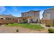 Home's beautiful backyard with a covered patio and a well-maintained green lawn at 10224 E Talameer Ave, Mesa, AZ 85212