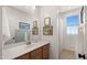 Well-lit bathroom features neutral colors, artwork, and a shower-tub combination at 10224 E Talameer Ave, Mesa, AZ 85212