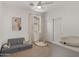 Cozy bedroom designed for a play and comfort, with a soft sofa and entertainment accessories at 10224 E Talameer Ave, Mesa, AZ 85212