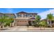 Charming two-story home with a neutral color palette, attached garage, and professionally landscaped front yard at 10224 E Talameer Ave, Mesa, AZ 85212