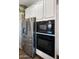 Close-up of kitchen appliances including a stainless steel refrigerator, microwave, and built-in oven at 10224 E Talameer Ave, Mesa, AZ 85212