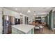 Open-concept kitchen flows into the dining and living area, featuring modern appliances and stylish decor at 10224 E Talameer Ave, Mesa, AZ 85212