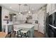 Stylish kitchen with white cabinets, quartz countertops, stainless steel appliances, and a center island at 10224 E Talameer Ave, Mesa, AZ 85212