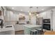 Bright kitchen with white cabinets, quartz countertops, stainless steel appliances, and a center island at 10224 E Talameer Ave, Mesa, AZ 85212