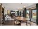 Open-concept living room and dining area with modern lighting, fireplace, and sliding glass doors to patio at 10224 E Talameer Ave, Mesa, AZ 85212