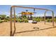 Community playground area featuring a shaded structure, lush landscaping, and a tire swing for fun at 10224 E Talameer Ave, Mesa, AZ 85212