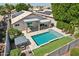 Aerial view showcasing the backyard pool, spa, covered patio, and well-maintained landscaping at 1057 W Laurel Ave, Gilbert, AZ 85233
