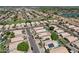 An aerial view of a quiet suburban neighborhood featuring single-Gathering homes with desert landscaping and community lake at 1057 W Laurel Ave, Gilbert, AZ 85233