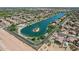 Aerial view of a scenic lakefront community with lush landscaping, waterfront homes, and a private island at 1057 W Laurel Ave, Gilbert, AZ 85233