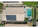 Aerial view of a home with a private pool, spa, solar panels, and well-maintained landscaping at 1057 W Laurel Ave, Gilbert, AZ 85233