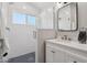 Well-lit bathroom with a glass shower enclosure and modern white tile, as well as a single sink vanity at 1057 W Laurel Ave, Gilbert, AZ 85233