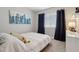 Stylish bedroom with natural light, accented by elegant drapes and a decorative cityscape art piece at 1057 W Laurel Ave, Gilbert, AZ 85233